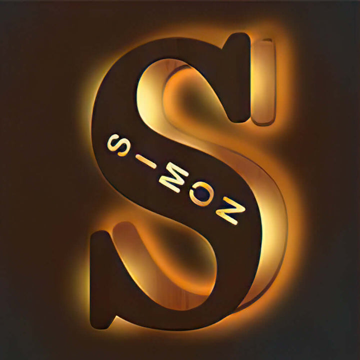 Illuminated S-shaped wooden letter lamp from the Enchanted Woodland Alphabet Lamp collection glowing warmly in the dark