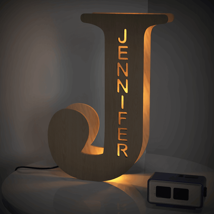 Illuminated wooden letter J lamp with the name Jennifer, adding personalized charm and warm glow to any space
