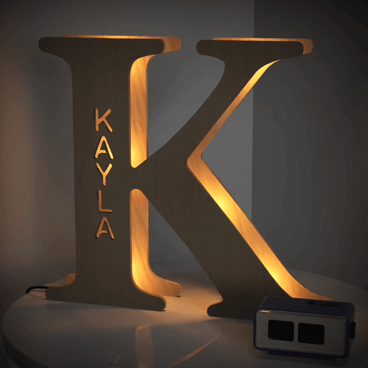 Enchanted Woodland Alphabet Lamp - Wooden letter K illuminated with a warm glow, perfect personalized night light for bedrooms and nurseries