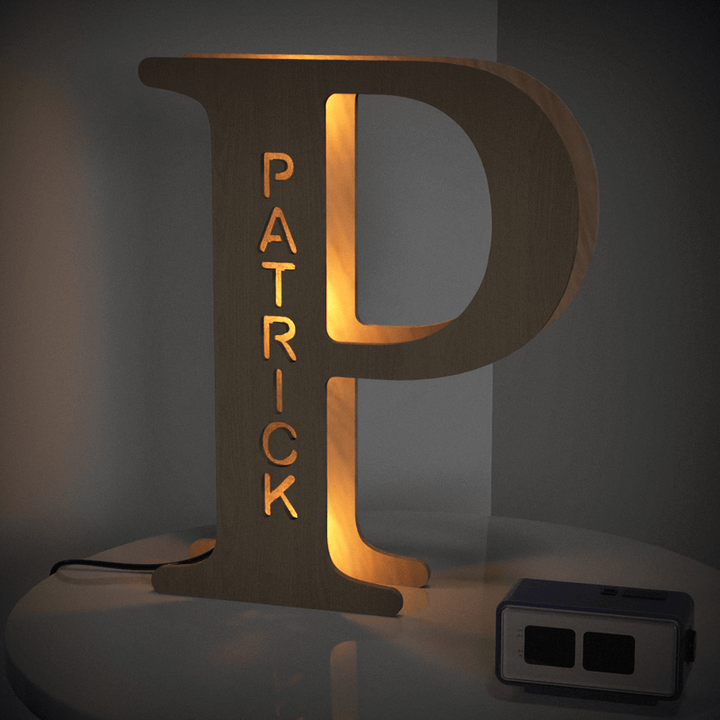 Enchanted Woodland Alphabet Lamp shaped like the letter P with the name Patrick, illuminated in a warm glow on a table.