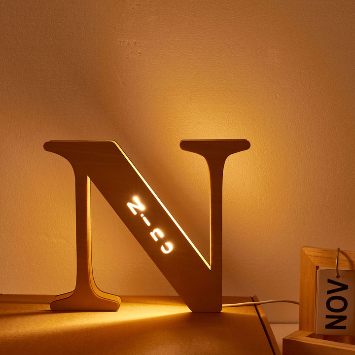 Enchanted Woodland Alphabet Lamp in N shape illuminating a room with warm light, personalized and customizable wooden night light